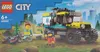 LEGO City packaging showing an all-terrain ambulance vehicle with minifigures and accessories in a natural setting with a city skyline in the background. Produktbild-Vorschau
