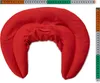 A red neck pillow is shown against a white background, with a measuring tape above and to the side. Produktbild-Vorschau