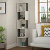 A modern living room corner with a white sofa, a tall, narrow bookshelf, and a window with plants. Anteprima dell’immagine prodotto