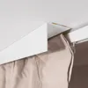 A close-up view of a white curtain rail system with a beige curtain hanging from it, attached to a white ceiling. Anteprima dell’immagine prodotto