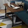 A mobile C-shaped side table with a laptop, phone, and book on it, placed next to a blue sofa on a patterned rug. Anteprima dell’immagine prodotto
