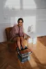 A woman is relaxing in a chair with her feet in a foot massager. Náhľad obrázku produktu