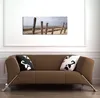 Wallario Premium Leinwandbild Sandstrand mit Holzpfählen am Produktbild-Vorschau 2