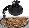 A roll of black plastic lawn edging and stakes are shown in the upper part of the image, with a circular garden bed with mulch and a tree trunk in the lower part. Náhled obrázku produktu