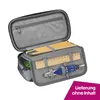 An open pencil case filled with stationery items. Produktbild-Vorschau