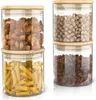Four glass storage jars with bamboo lids are stacked in two columns of two. Anteprima dell’immagine prodotto