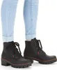 A pair of black lace-up boots worn with light blue cuffed jeans. Produktbild-Vorschau