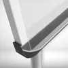 A close-up view of the corner of a white flip chart stand, showing the gray gutter and a black rubber foot. Produktbild-Vorschau