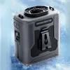 A gray and black portable waist fan is shown in a snowy or icy environment. Produktbild-Vorschau