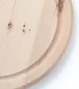 A close-up view of a round wooden cutting board with a juice groove. Produktbild-Vorschau