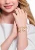 A close-up shot of a young girl's arm wearing a charm bracelet. Náhled obrázku produktu