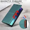 A teal leather flip wallet phone case is shown on a wooden surface next to a laptop. Produktbild-Vorschau