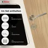 A door handle set with its included accessories displayed on a wooden door. Produktbild-Vorschau