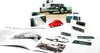 A collection of model car parts, books, and toy cars are arranged on a white background. Produktbild-Vorschau