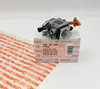 A STIHL carburetor is placed on its original packaging box, with a white background. A clear plastic sheet with STIHL branding is partially visible in the foreground. Produktbild-Vorschau