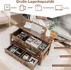 A rustic wooden coffee table with its top lifted, revealing storage compartments filled with books, headphones, and other items. The table is placed in a living room setting with a sofa visible in the background. Náhľad obrázku produktu