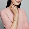 A woman's arm wearing a bracelet with a heart-shaped charm. Produktbild-Vorschau