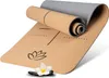 A rolled-up yoga mat with a lotus flower design and a small flower and stones in the foreground. Produktbild-Vorschau