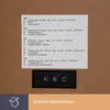 A close-up of a digital clock's control panel and multilingual instructions. Podgląd zdjęcia produktu