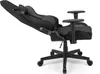 A black gaming chair with its backrest reclined, shown from a side angle against a white background. Produktbild-Vorschau