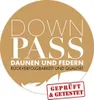 A circular logo with text and a feather illustration. Produktbild-Vorschau