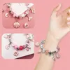 A collage of images showing a charm bracelet being worn on a wrist, and close-ups of the bracelet and its charms. Produktbild-Vorschau