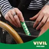 A person is putting a VIVIL mint stick into a black handbag. Produktbild-Vorschau