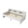 A white daybed with a slatted mattress base and a built-in headboard with shelves, shown against a white background. Náhled obrázku produktu