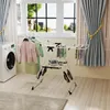 A laundry room scene with a washing machine, a drying rack with clothes, and curtains. Podgląd zdjęcia produktu