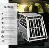 A dog transport box is placed in the trunk of a car, with descriptive text on the left side. Produktbild-Vorschau