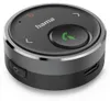 A close-up, studio shot of a round, black Bluetooth transmitter with silver trim. Voir les images du produit