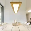 A modern dining room with a wooden table and chairs, illuminated by a triangular pendant light. Náhled obrázku produktu