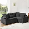 A dark gray sectional sofa with multiple cushions is shown in a well-lit room with a large window and a door in the background. Produktbild-Vorschau