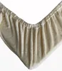A close-up view of a beige, plush fitted sheet with elastic gathering at the edge. Produktbild-Vorschau