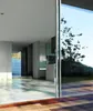 A modern interior with large glass doors overlooking a natural landscape. Produktbild-Vorschau