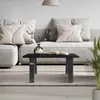 A modern living room scene with a sofa, coffee table, and plant. Náhled obrázku produktu
