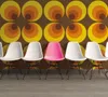 A row of chairs against a retro-patterned wall. Produktbild-Vorschau