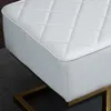 A close-up of a white quilted bench with a gold metal frame. Náhľad obrázku produktu