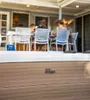 People sitting at a table on a patio with a hot tub in the foreground. Náhled obrázku produktu