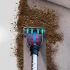 A vacuum cleaner head is shown cleaning dirt from a textured surface, with animated arrows indicating suction. Náhľad obrázku produktu