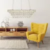 A modern living room with a wooden cabinet, a yellow armchair, and a crystal chandelier. Podgląd zdjęcia produktu