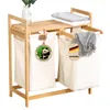 A bamboo laundry sorter with two white fabric bags, folded towels on top, and decorative tags. Podgląd zdjęcia produktu
