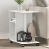 A white side table with storage compartments and wheels, placed next to a sofa. It is decorated with a vase of flowers, a diffuser, a lantern, and two decorative vases. Produktbild-Vorschau