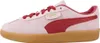 A side view of a single pink Puma sneaker with red accents and a gum sole. Produktbild-Vorschau