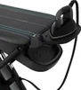 A close-up view of a black ironing board with an iron resting on its holder. Produktbild-Vorschau