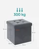 A gray ottoman with tufted top and dimensional markings, along with an indicator for weight capacity. Produktbild-Vorschau