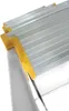 A close-up view of the top steps of an aluminum ladder with yellow protective caps. Anteprima dell’immagine prodotto