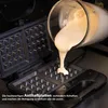 Batter being poured into an open waffle maker. Náhľad obrázku produktu