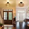 A split image showing two different entryway scenes, each featuring a rattan-style ceiling light. Produktbild-Vorschau