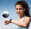 A woman wearing a fitness outfit and earbuds is checking her smartwatch outdoors. Náhled obrázku produktu